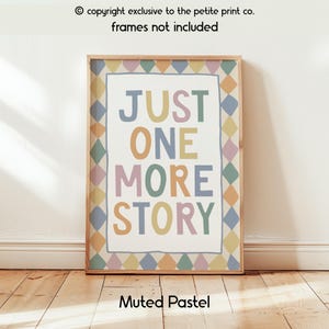 May include: A rectangular wall art print featuring the text JUST ONE MORE STORY in muted pastel colours. The design includes a border of alternating diamond shapes in blue, yellow, pink, and green. The print is presented in a wooden frame.