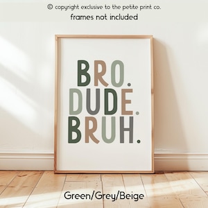 May include: Framed wall art with the words "BRO. DUDE. BRUH." in green, grey, and beige. The text is centered on a white background. The frame is a light brown color. The text "Green/Grey/Beige" is at the bottom.