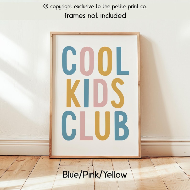 May include: A rectangular wall art print featuring the text COOL KIDS CLUB in a bold, sans-serif font. The letters are colored in alternating shades of muted blue, soft pink, and mustard yellow against a plain white background.