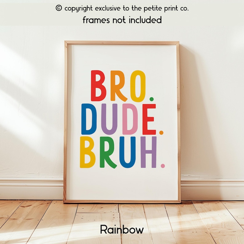 May include: A framed print with the words "BRO. DUDE. BRUH." in rainbow colors. The print is in a wooden frame and is displayed against a white wall. The word "Rainbow" is at the bottom of the print.