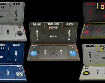 May include: A collection of six futuristic game consoles in various colors, including gray, black, and blue. Each console displays the text "BLUE", "ROUND", and "RED", along with numbers and the word "MAP". The consoles have buttons and indicator lights.