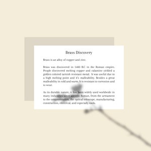 May include: A white card with the title "Brass Discovery" and text describing brass as an alloy of copper and zinc, its discovery in 1400 B.C., and its uses in various industries.