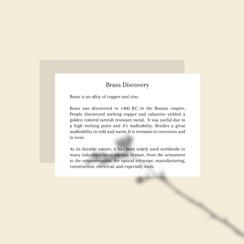 May include: A white card with the title "Brass Discovery" and text describing brass as an alloy of copper and zinc, its discovery in 1400 B.C., and its uses in various industries.