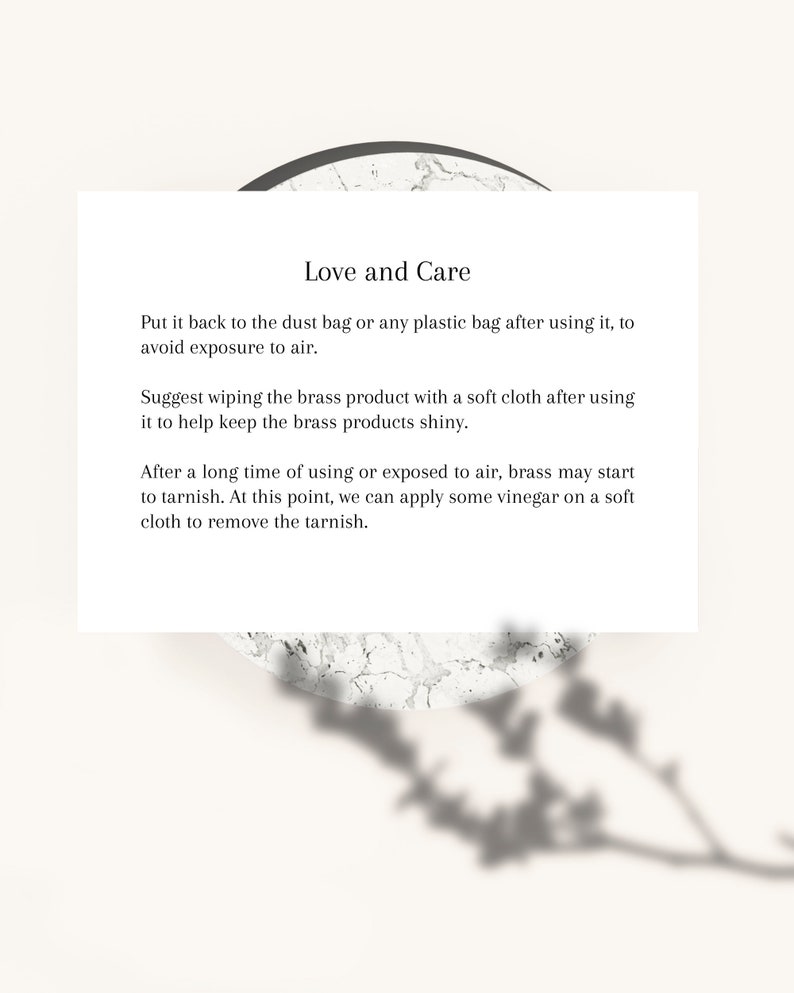 May include: A white card with the text "Love and Care" and instructions for brass product maintenance. The card is set against a neutral background with a marble-like texture and a plant shadow.