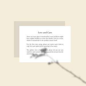 May include: A cream-colored card with the text "Love and Care" and care instructions for a water glass. The text describes the handcrafted nature of the glass and provides cleaning instructions.