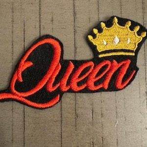 May include: Red embroidered "Queen" with a gold crown on a black background.