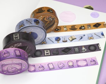 May include: Five rolls of washi tape with a witchy theme. The tapes feature illustrations of cauldrons, potions, crystals, and other magical objects. The tapes are in various colors, including purple, black, and blue.