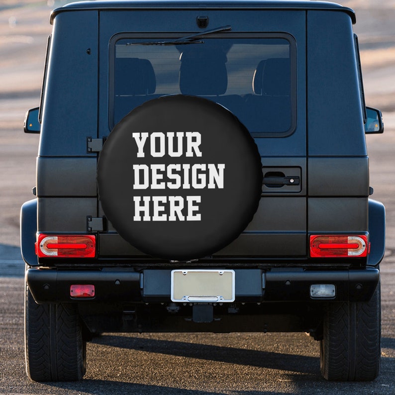 May include: Black SUV with a spare tire cover that says "YOUR DESIGN HERE" in white text.