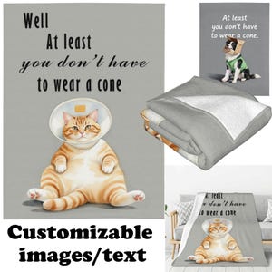 May include: A gray blanket with a print of a cat wearing a cone collar and the text "Well, At least you don't have to wear a cone." The blanket also features a dog with a cone and the text "At least you don't have to wear a cone."