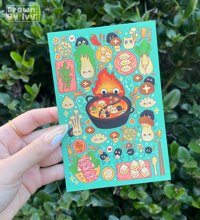 May include: A teal postcard featuring a colorful illustration of a hot pot with various food items and cute cartoon characters. The text "Drawn by Ivy" is in the upper left corner. The design includes mushrooms, dumplings, and vegetables.