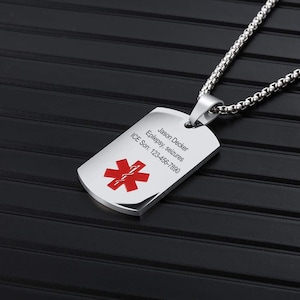 May include: A silver medical alert pendant on a chain. The tag features a red medical symbol and the text: Jason Decker, Epilepsy, seizures, ICE Son: 123-456-7890.