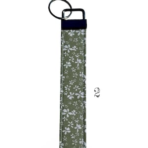 Handmade Fabric Wristlet Durable Construction Keychain Metal Hardware Details Floral Pattern Design Gingham Style Accent Vintage Inspired Look Shabby Chic Aesthetic Multiple Color Options Pink Sage Green Cream Six Inch Length Practical Car