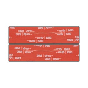 May include: Two rectangular adhesive strips with red backing. The text "3M VHB" and "3M" are printed in white on the red surface. The strips are designed for bonding and mounting applications.