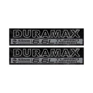 May include: Two black and gray Duramax 6.6L Turbo Diesel decals. The decals feature the text "DURAMAX" in white, with "Allison Transmission" and "6.6L TURBO DIESEL" also displayed.