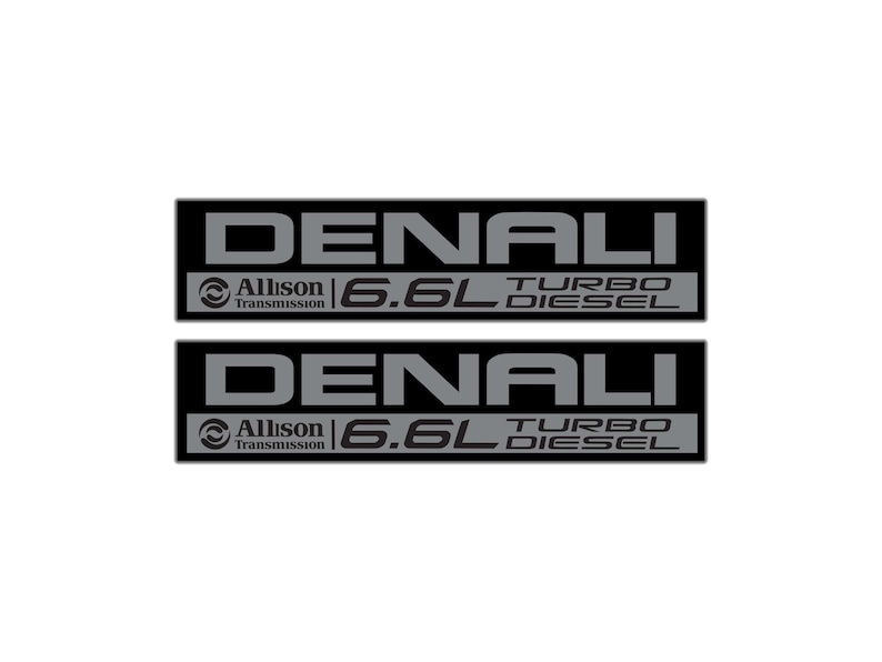 May include: Two black rectangular Denali emblems with gray text. Each emblem has the word "DENALI" at the top, "Allison Transmission" and a logo, and "6.6L TURBO DIESEL" at the bottom. The emblems are for a vehicle.