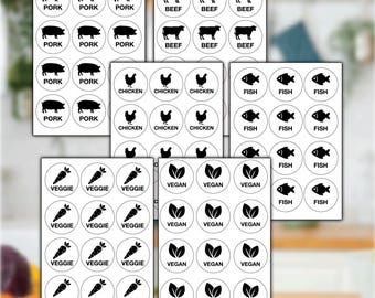 May include: A selection of circular food labels featuring black illustrations and text. Labels include "PORK", "BEEF", "CHICKEN", "FISH", "VEGGIE", and "VEGAN". The labels are arranged in various groups.