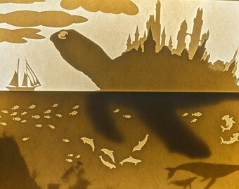 La ciudad errante, caja de luz / caja de sombras de papel recortado de fantasía de tortuga
