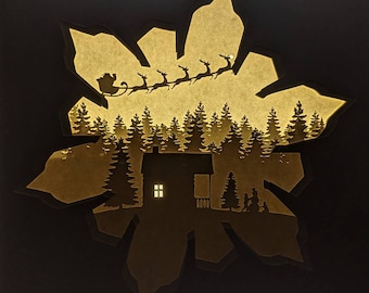 Invierno en la cabaña: caja de luz/caja de sombras recortada en papel con temática de Navidad, copos de nieve y Papá Noel