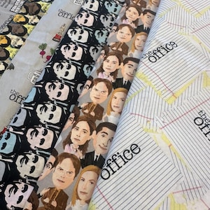 May include: Four strips of fabric featuring The Office themes. One strip has black and white character faces, another has colourful caricatures of characters, one has icons like mugs and beets, and the last has lined paper with The Office logo.