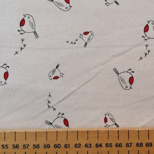 May include: White fabric with a repeating pattern of red-breasted robins. The robins are black and white with red accents and are depicted in a simple, stylized design.