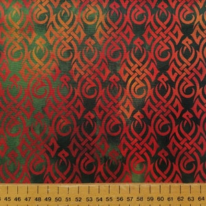 May include: Red and green fabric with a repeating pattern of stylised Celtic knots. The fabric has a gradient effect, with the red colour fading to green.