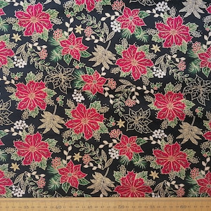 May include: Black fabric with a repeating pattern of red poinsettia flowers, gold leaves, and green foliage.