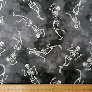May include: A black and white fabric with a repeating pattern of skeletons dancing. The skeletons are white against a dark grey background.