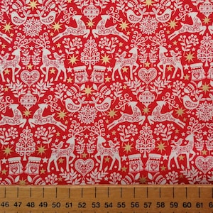 May include: Red fabric with a white Scandinavian Christmas pattern. The pattern includes reindeer, birds, stars, trees, and hearts. The fabric has a gold metallic sheen.