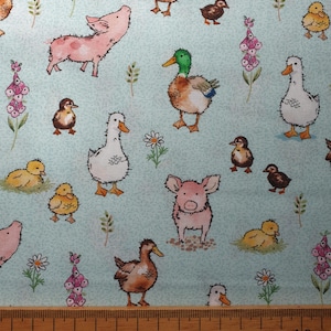 May include: A blue and white fabric with a repeating pattern of ducks, pigs and chicks. The fabric has a light blue background with a subtle texture.