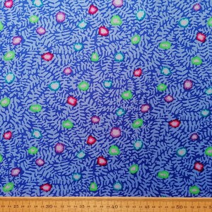 May include: Blue fabric with a white, pink, green, and blue abstract pattern. The fabric has a textured surface.