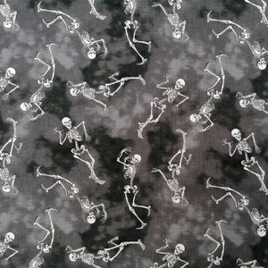 May include: A black and white fabric with a repeating pattern of skeletons dancing. The skeletons are white and the background is a dark grey with a mottled, tie-dye effect.