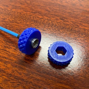 May include: Two blue plastic connector pieces. One piece has a threaded hole and the other has a hexagonal hole.