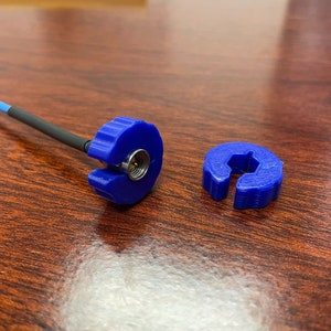 May include: Two blue plastic connectors for a coaxial cable. One connector has a center pin and the other is a ring.