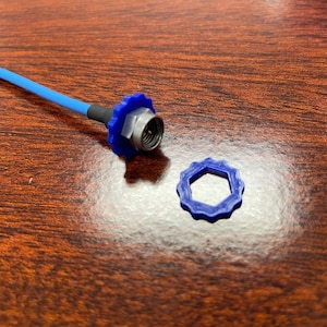 May include: A blue coaxial cable with a blue and silver connector and a separate blue connector cap.