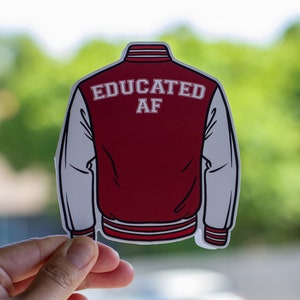 May include: A red and white varsity jacket sticker with the text "EDUCATED AF" on the back.