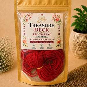 May include: A gold-colored stand-up pouch containing a coil of red cotton thread. The label reads Treasure Deck, Red Thread (Lal Dhaga), Nazar Suraksha, Natural, Pure, Traditional, 100% Cotton, Vibrant Colors, and Traditional & Sacred.
