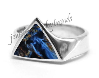 May include: A silver ring with a triangular blue and gold gemstone set in the center. The ring is designed with a thick band and a triangular setting.