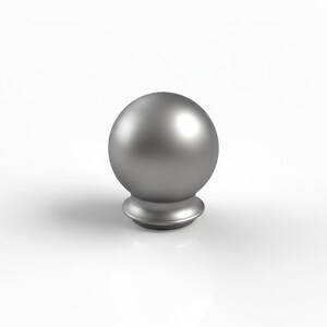 May include: A brushed silver metal finial. It has a spherical top and a decorative base. The finial is designed to be mounted on a rod or pole. The design is simple and modern, with clean lines and a metallic finish.