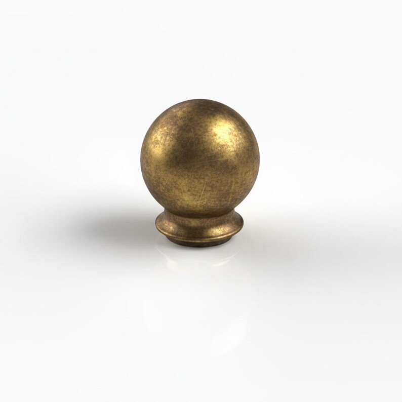 May include: A bronze-coloured, spherical furniture knob with a textured surface. The knob sits on a short, rounded base. The design is simple and classic, suitable for various furniture styles.