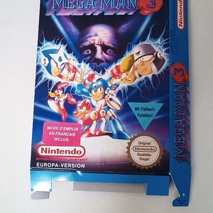 May include: A blue and white Nintendo game box for Mega Man 3. The box features a cartoon image of Mega Man and other characters from the game. The text "MEGA MAN 3" is printed in large, white letters on the front of the box. The box also includes the text "Original Nintendo Qualitäts-Siegel" and "Mit Paßwort-Funktion!"