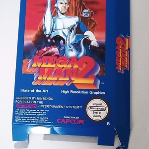 Pode incluir: Uma caixa azul e amarela para o videogame Mega Man 2 para o Nintendo Entertainment System. A caixa apresenta uma imagem de Mega Man em uma pose de luta. O texto na caixa diz "State-of-the-Art High Resolution Graphics Licensed by Nintendo for Play on the Nintendo Entertainment System." A caixa também inclui o selo de qualidade da Nintendo.