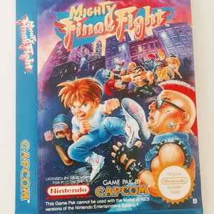 May include: A blue and brown box for the Nintendo Entertainment System game Mighty Final Fight. The box features a colorful illustration of the game's characters fighting in a city street. The text "Weltbekannter Arcaden-Spiele-Entwickler CAPCOM" is printed on the top of the box. The text "Mighty Final Fight" is printed in large, bold letters on the front of the box. The text "Licensed by Nintendo for play on the Nintendo Entertainment System" is printed on the bottom of the box.