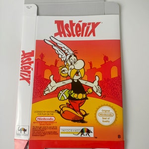 May include: Asterix Nintendo Entertainment System game box. The box features a vibrant illustration of Asterix, the main character, with a red and orange background. The Nintendo seal of quality is visible.