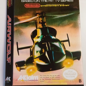 May include: Airwolf video game box for the Nintendo Entertainment System. The box features a helicopter graphic and the game title in red and white. The box is black and has the Nintendo logo.