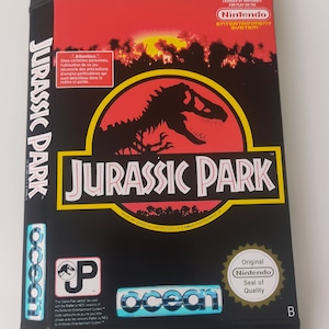 May include: A red, black, and yellow box for the Nintendo Entertainment System game Jurassic Park. The box features a black silhouette of a dinosaur on a red background. The game is licensed by Nintendo and published by Ocean.