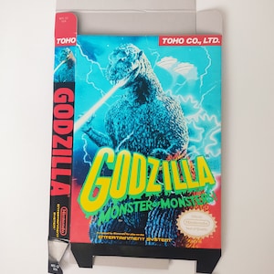 Może przedstawiać: Tekturowe pudełko na grę wideo Nintendo Entertainment System "Godzilla: Monster of Monsters". Pudełko zawiera niebieski i zielony obraz Godzilli na żółtym tle. Tekst "Godzilla: Monster of Monsters" jest wydrukowany żółtymi i zielonymi literami. Pudełko zawiera również pieczęć jakości Nintendo.