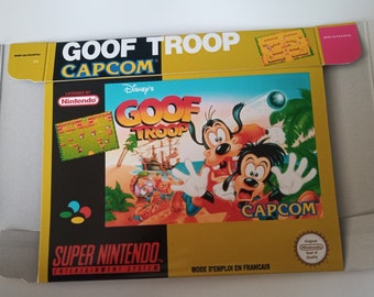 May include: A yellow, black, and white Super Nintendo game box for Goof Troop, licensed by Disney and published by Capcom. The box features a cartoon image of Goofy and his son Max on a tropical island.