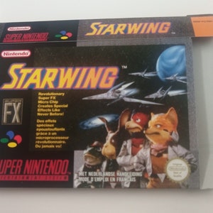 Pode incluir: Uma caixa de cartucho de jogo Super Nintendo para Starwing, com um design preto e prateado com uma imagem dos personagens do jogo. A caixa tem o texto "Starwing" em letras brancas grandes e "Super Nintendo" em letras brancas menores. A caixa também tem um pequeno adesivo prateado com o texto "FX" nele.