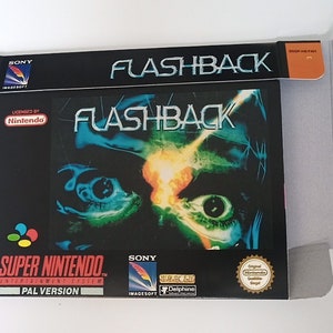 May include: A black Super Nintendo game cartridge box with a blue and green image of a man's face with glowing eyes. The title of the game is "Flashback" and the box is labeled "PAL Version".