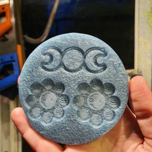 May include: A blue round resin mould with three crescent moons and two flower-shaped designs with moons and stars inside.